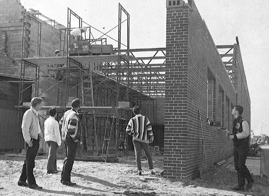 Students observe the ongoing construction of the new NDHS gymnasium in 1964